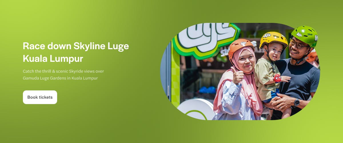 Family at Skyline Luge Kuala Lumpur, wearing helmets and smiling.